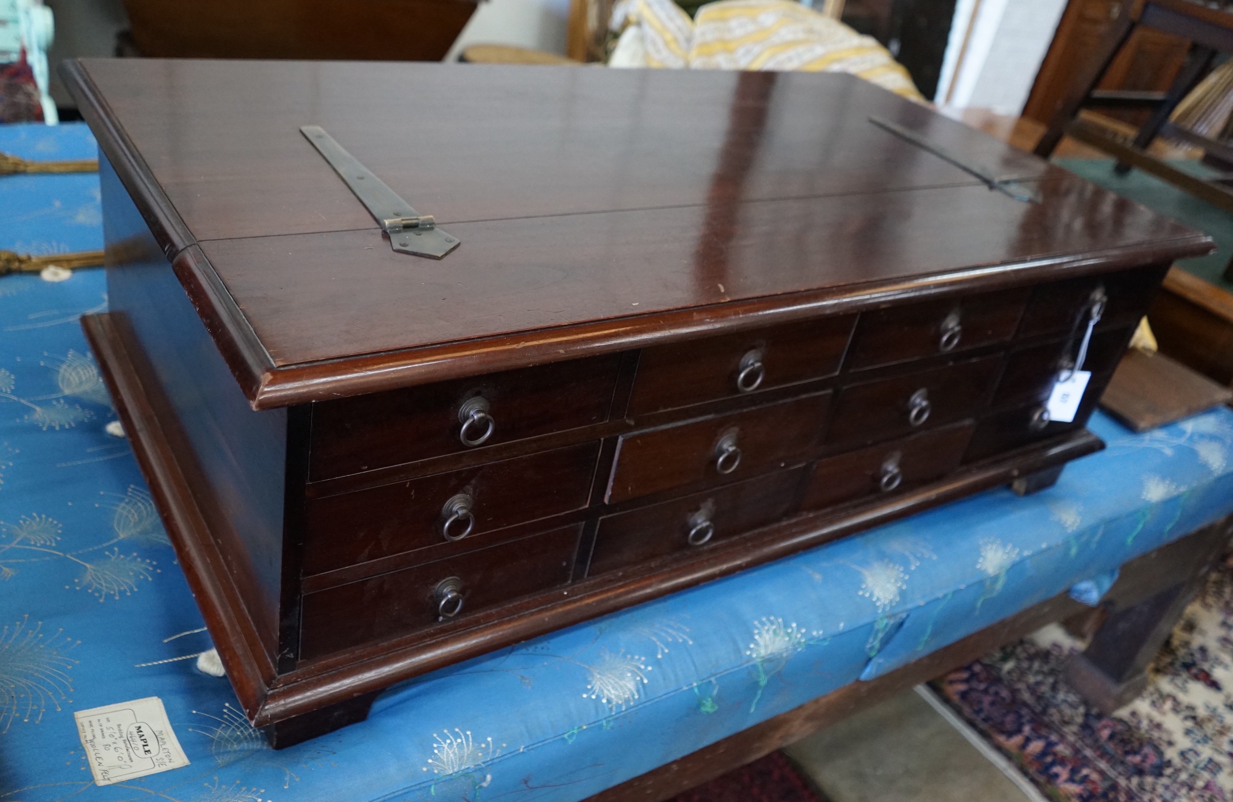 An Indonesian hardwood hinged top 12-drawer coffee table/storage chest, width 118cm, depth 66cm, height 36cm